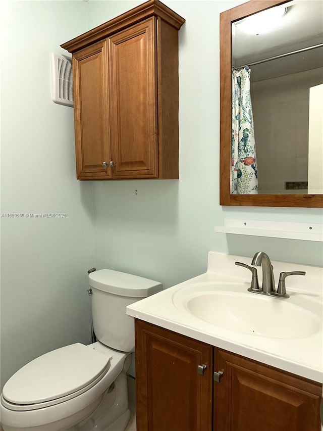 bathroom featuring vanity and toilet