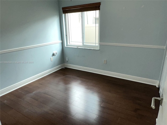 spare room featuring dark wood-type flooring