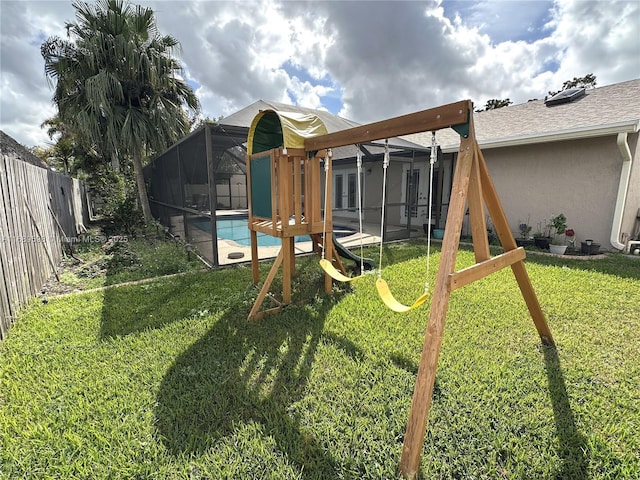 view of play area with a fenced in pool and a lawn