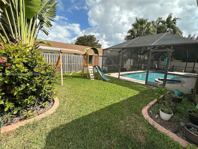 view of yard featuring a fenced in pool, a lanai, and a playground