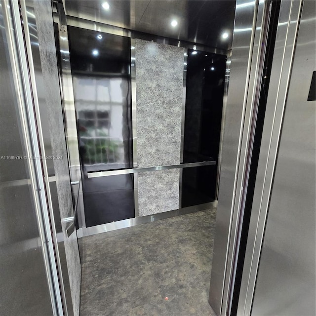 room details with concrete floors and elevator