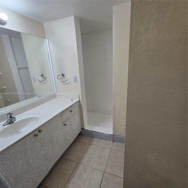 bathroom with vanity, tile patterned floors, and tiled shower