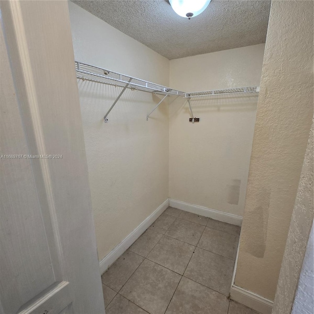 spacious closet with tile patterned floors