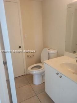 bathroom featuring toilet, vanity, and tile patterned floors