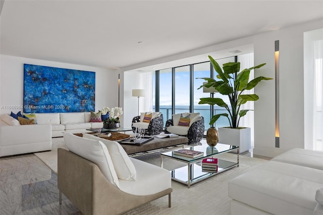 living room with a water view and a wall of windows