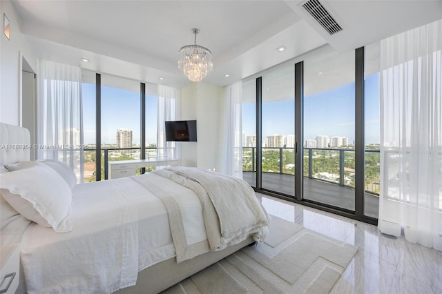 bedroom featuring multiple windows, access to outside, an inviting chandelier, and a wall of windows