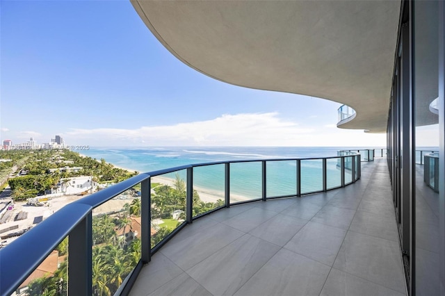 balcony with a beach view and a water view