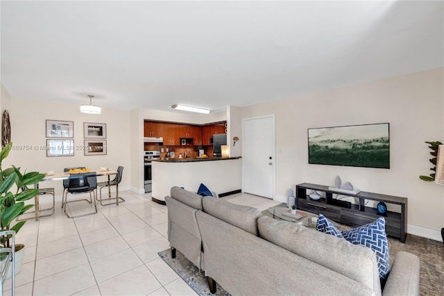 living room featuring baseboards and light tile patterned floors