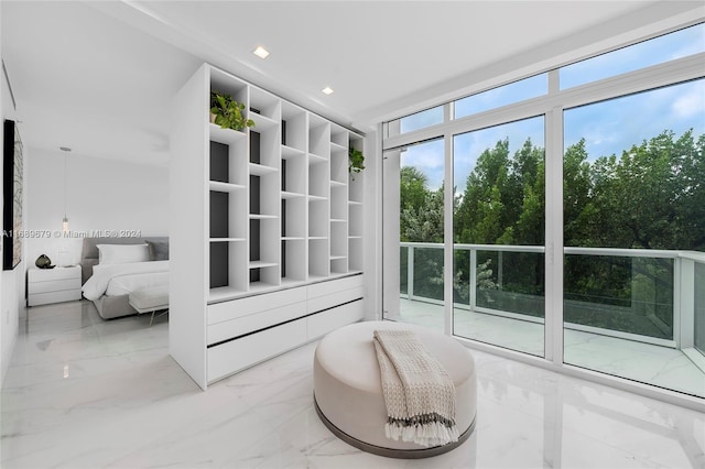 bedroom with floor to ceiling windows and access to outside