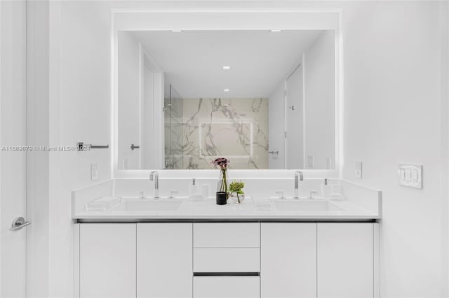 bathroom with walk in shower and vanity