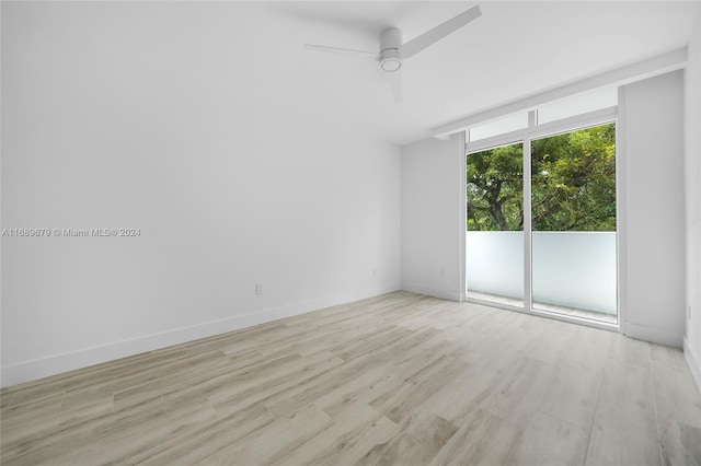 empty room featuring light wood-type flooring and ceiling fan