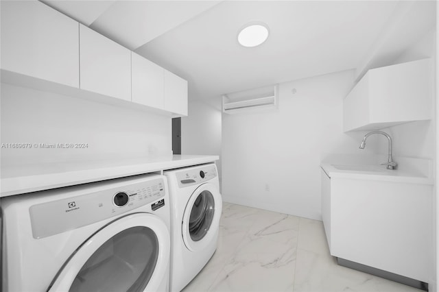 laundry area featuring washing machine and dryer, cabinets, and a wall mounted AC