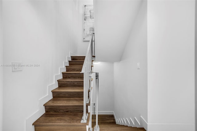 staircase featuring hardwood / wood-style floors