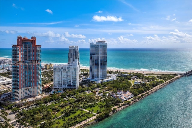 birds eye view of property featuring a beach view and a water view