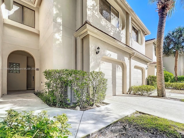 doorway to property with a garage