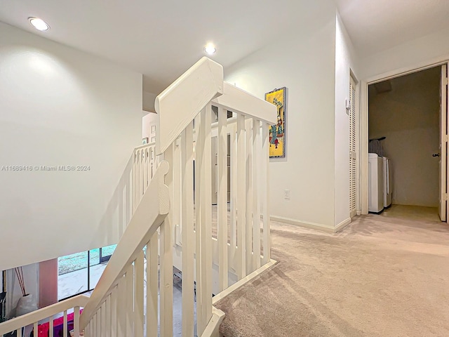 hall with light colored carpet