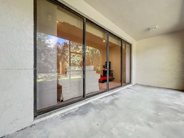 exterior space with a textured ceiling and concrete floors