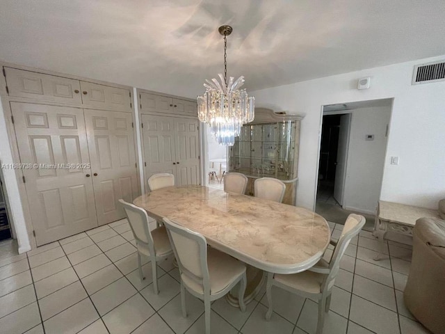 dining room featuring light tile patterned floors and a chandelier