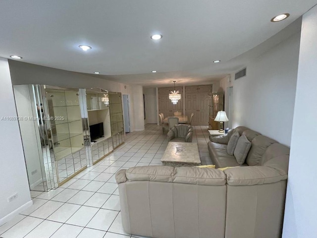 tiled living room with a chandelier