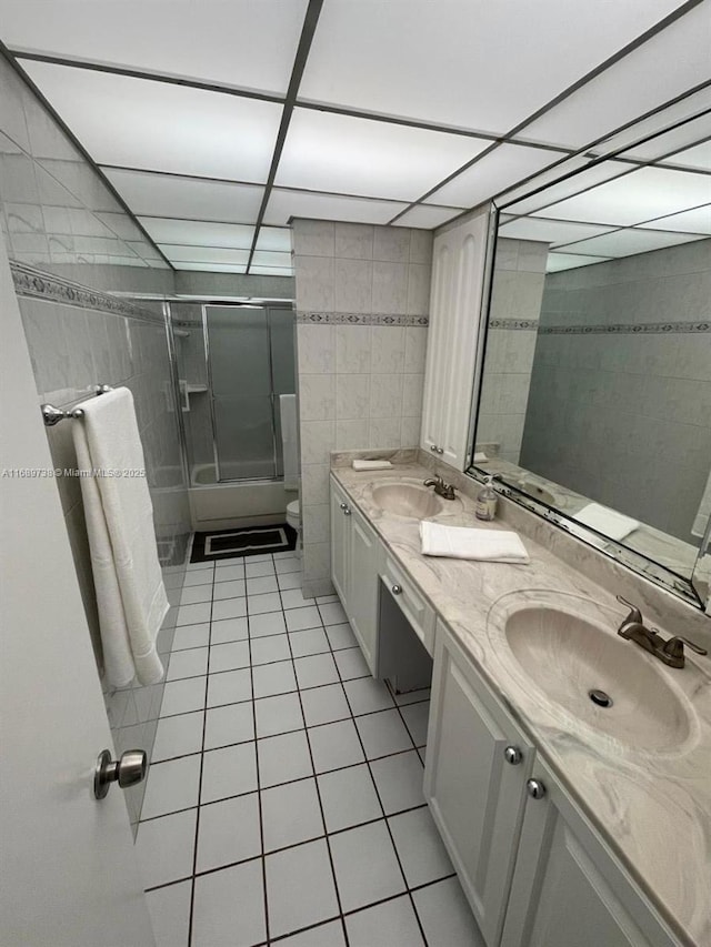 bathroom featuring tile patterned flooring, vanity, and tile walls