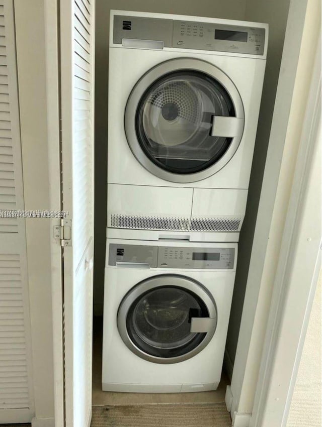 washroom featuring stacked washer and dryer