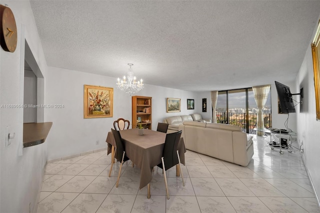 dining space with an inviting chandelier, floor to ceiling windows, and a textured ceiling