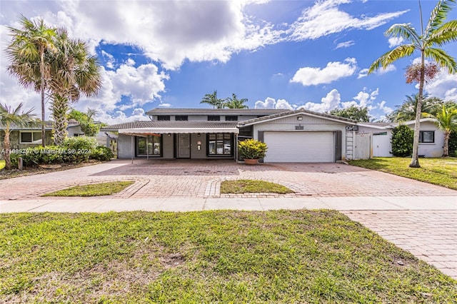 view of front of home featuring a garage and a front yard