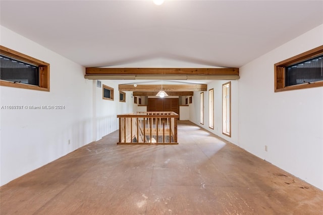 empty room featuring vaulted ceiling