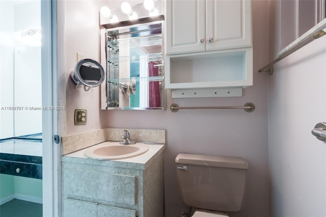 bathroom featuring vanity, tile patterned floors, and toilet