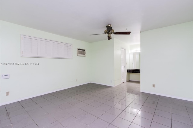 tiled empty room with a wall unit AC and ceiling fan