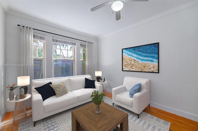 living room with hardwood / wood-style flooring, ceiling fan, and ornamental molding