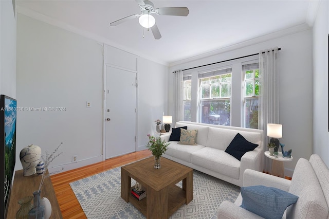 living room featuring ceiling fan, wood-type flooring, and ornamental molding