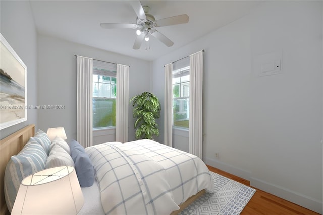 bedroom with hardwood / wood-style floors and ceiling fan