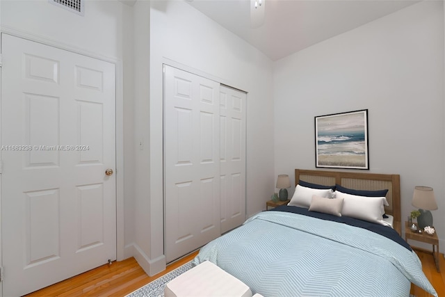 bedroom featuring hardwood / wood-style floors and a closet