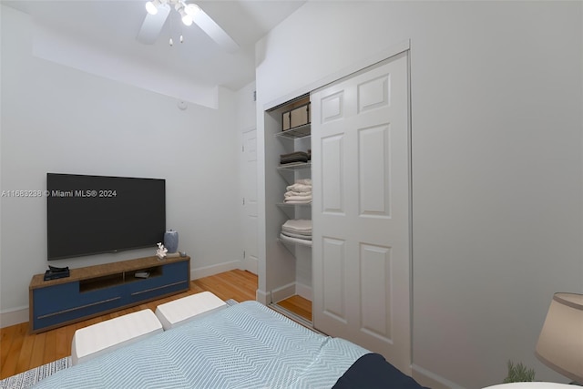 bedroom with a closet, ceiling fan, and light hardwood / wood-style floors