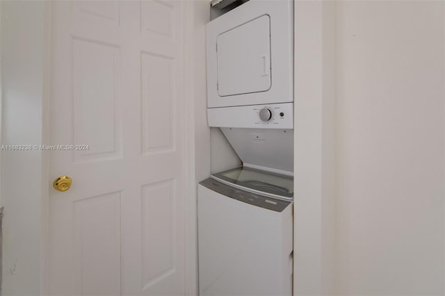 washroom featuring stacked washing maching and dryer