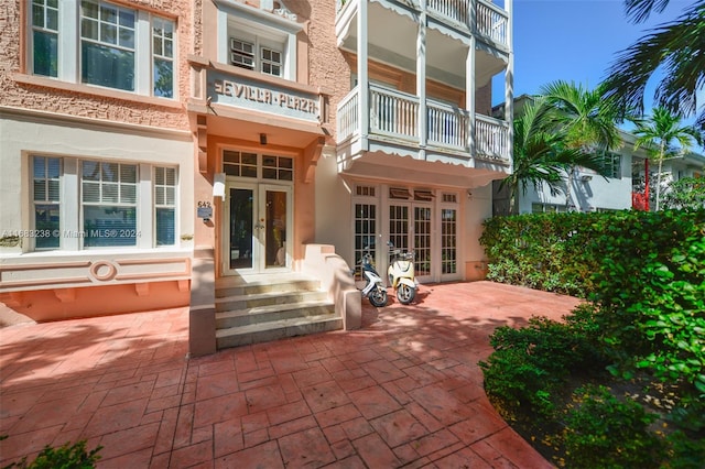 rear view of house featuring french doors and a balcony