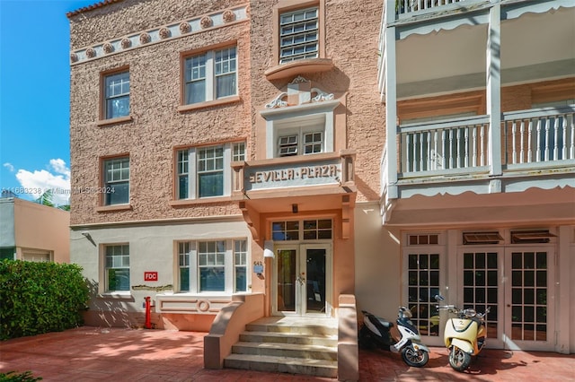 back of property featuring french doors and a balcony