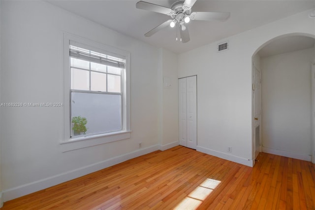 empty room with ceiling fan and light wood-type flooring