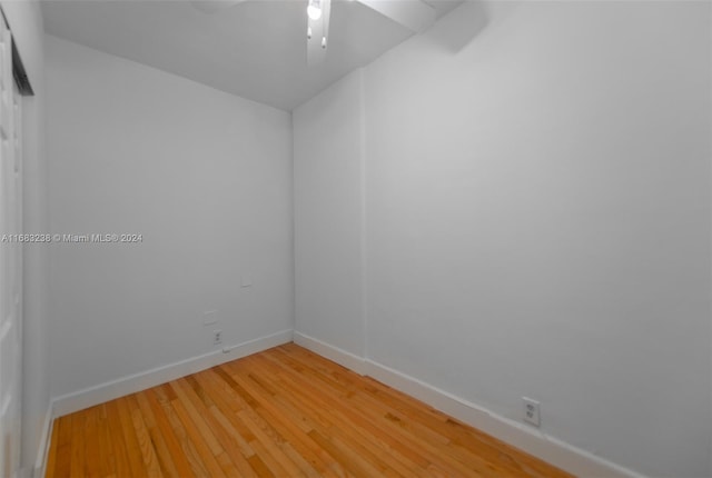 empty room with hardwood / wood-style flooring and ceiling fan