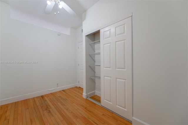 unfurnished bedroom with a closet, hardwood / wood-style floors, and ceiling fan