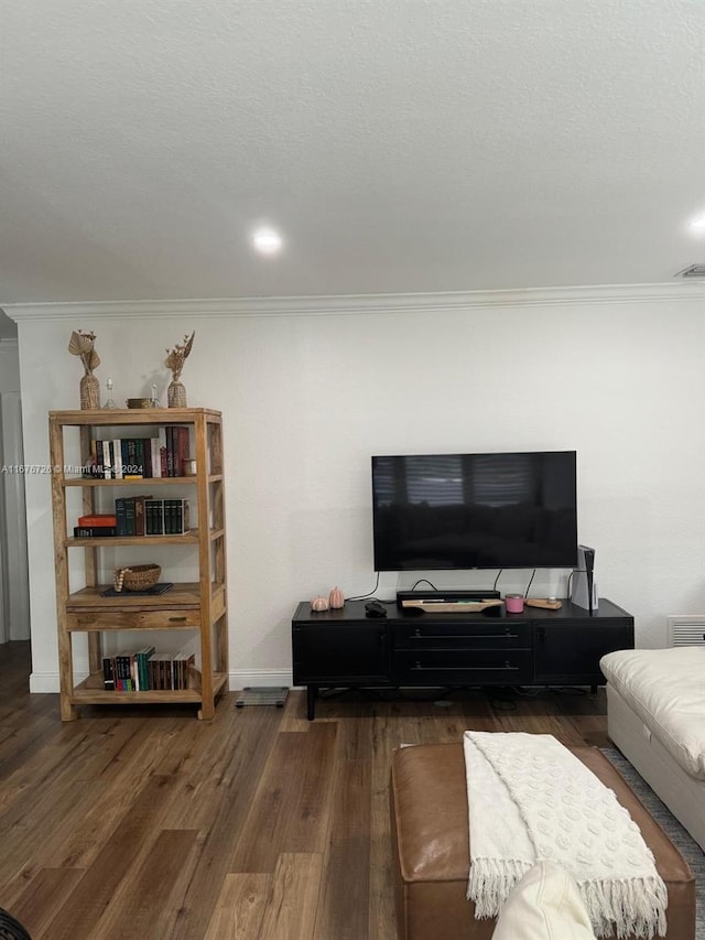 living room featuring dark hardwood / wood-style flooring and crown molding