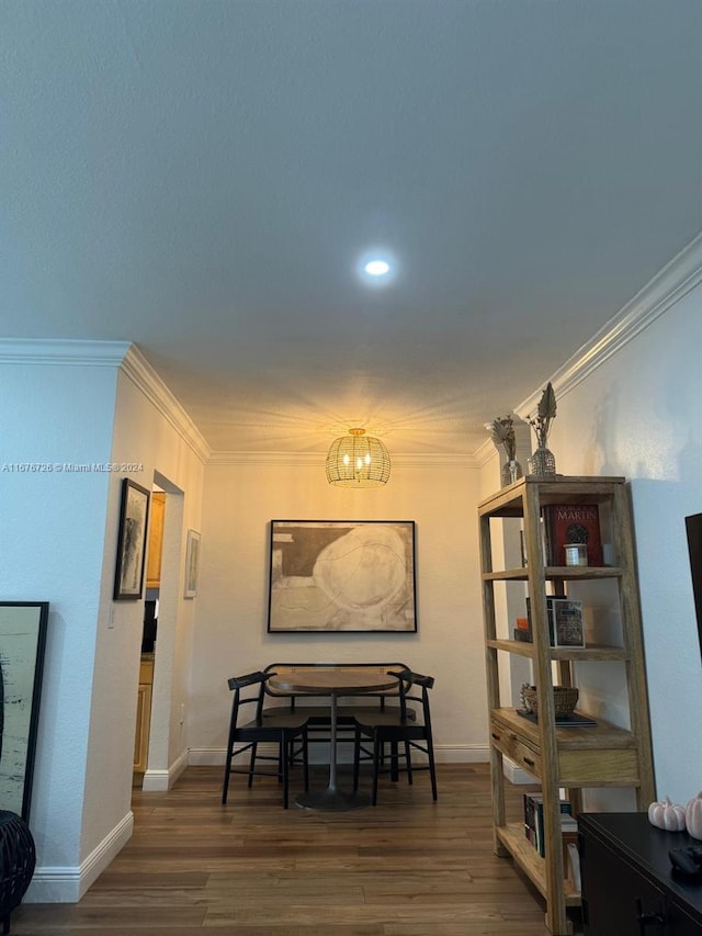 dining space with ornamental molding, dark hardwood / wood-style flooring, and a notable chandelier