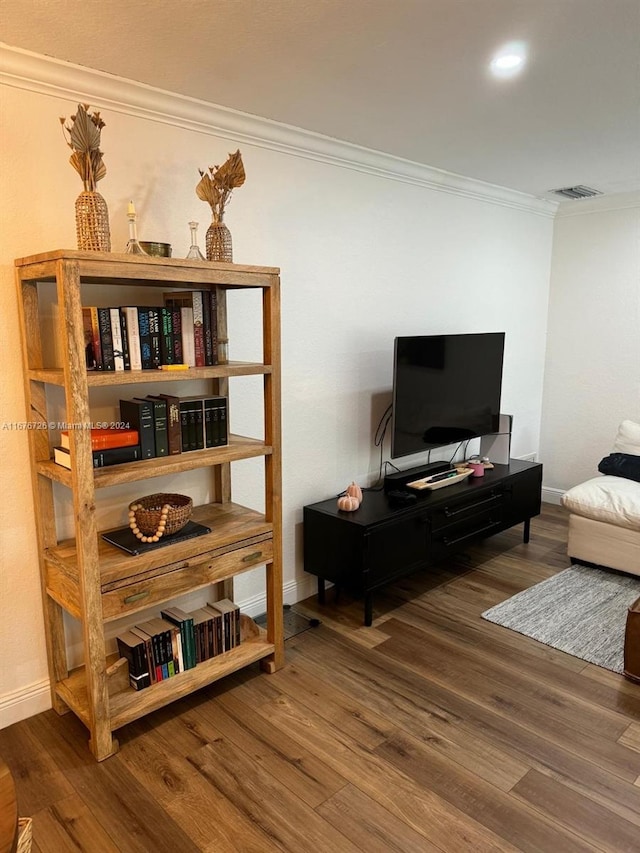 interior space featuring ornamental molding and hardwood / wood-style flooring