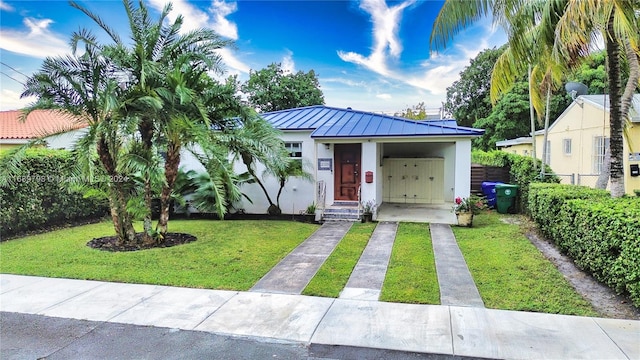 bungalow-style house featuring a front yard and a carport