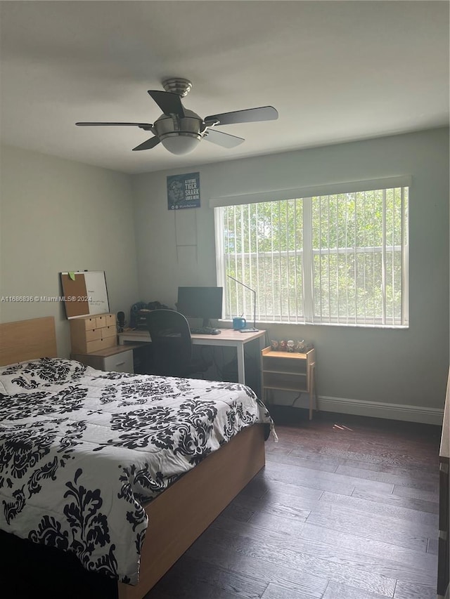 bedroom with dark hardwood / wood-style flooring and ceiling fan