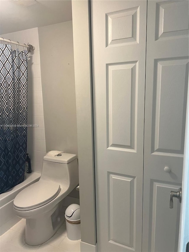 bathroom with walk in shower, tile patterned flooring, and toilet