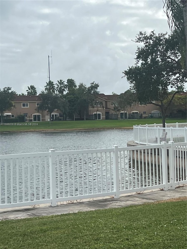 exterior space featuring a water view and a lawn