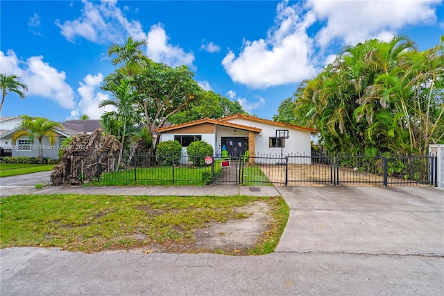 view of front of home featuring a front yard and a garage