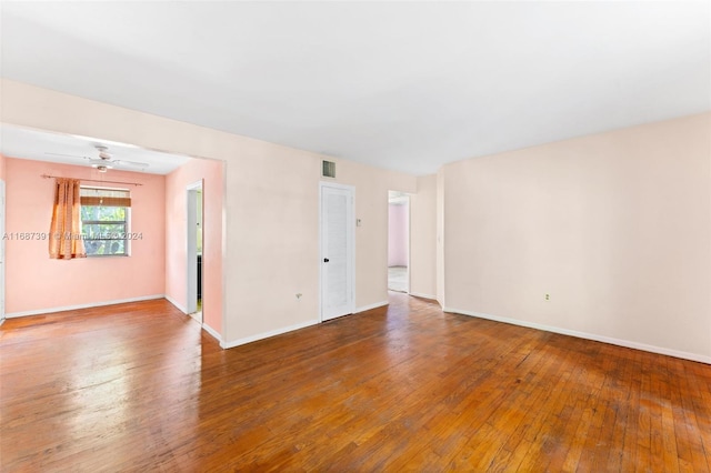 empty room featuring hardwood / wood-style flooring and ceiling fan